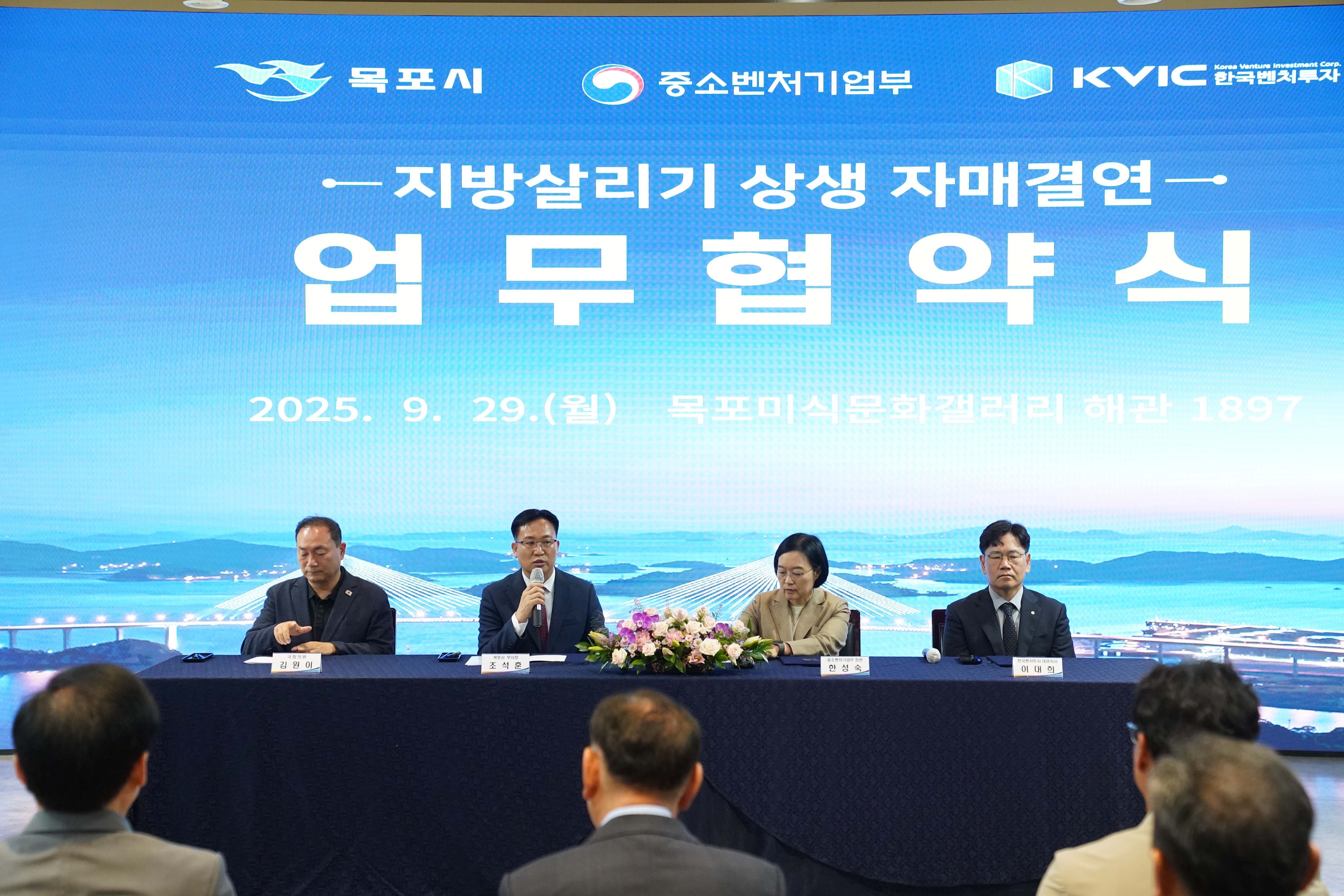 '지방살리기 상생 자매결연 업무협약식' 현장 전경. '2025. 9. 29.(월) 목포미식문화갤러리 해관 1897' 텍스트와 목포시, 중소벤처기업부, KVIC 한국벤처투자 로고가 보임.